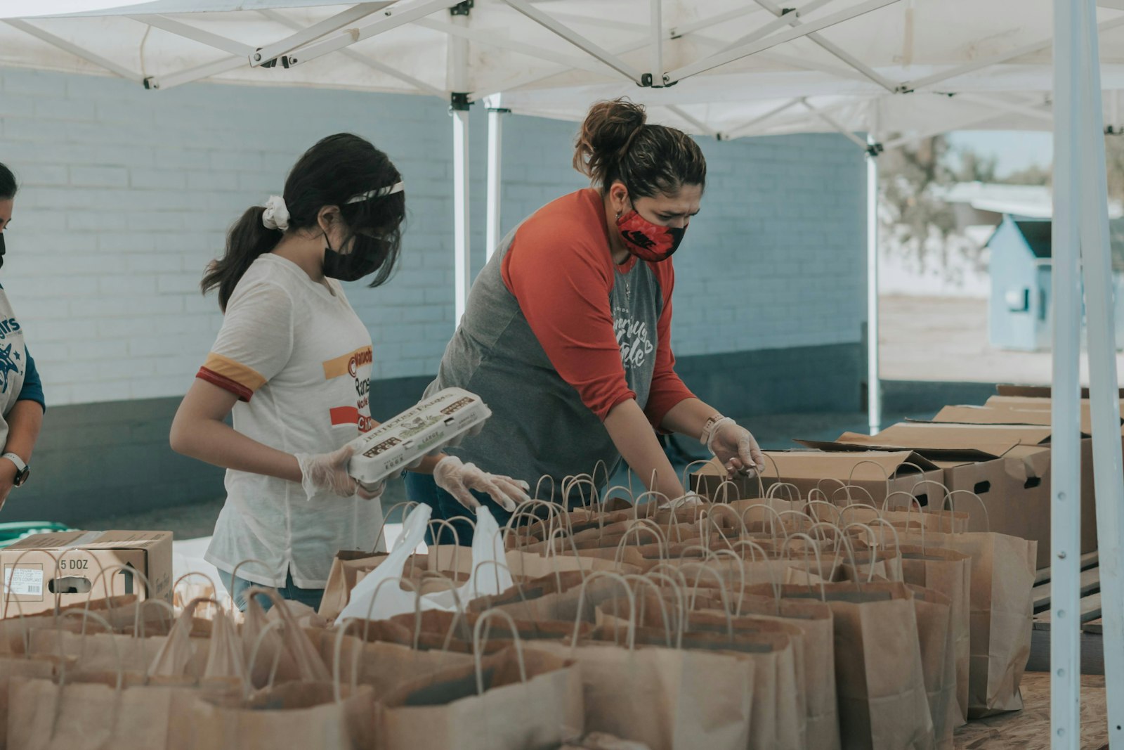 Volunteers packing food donations at a community distribution